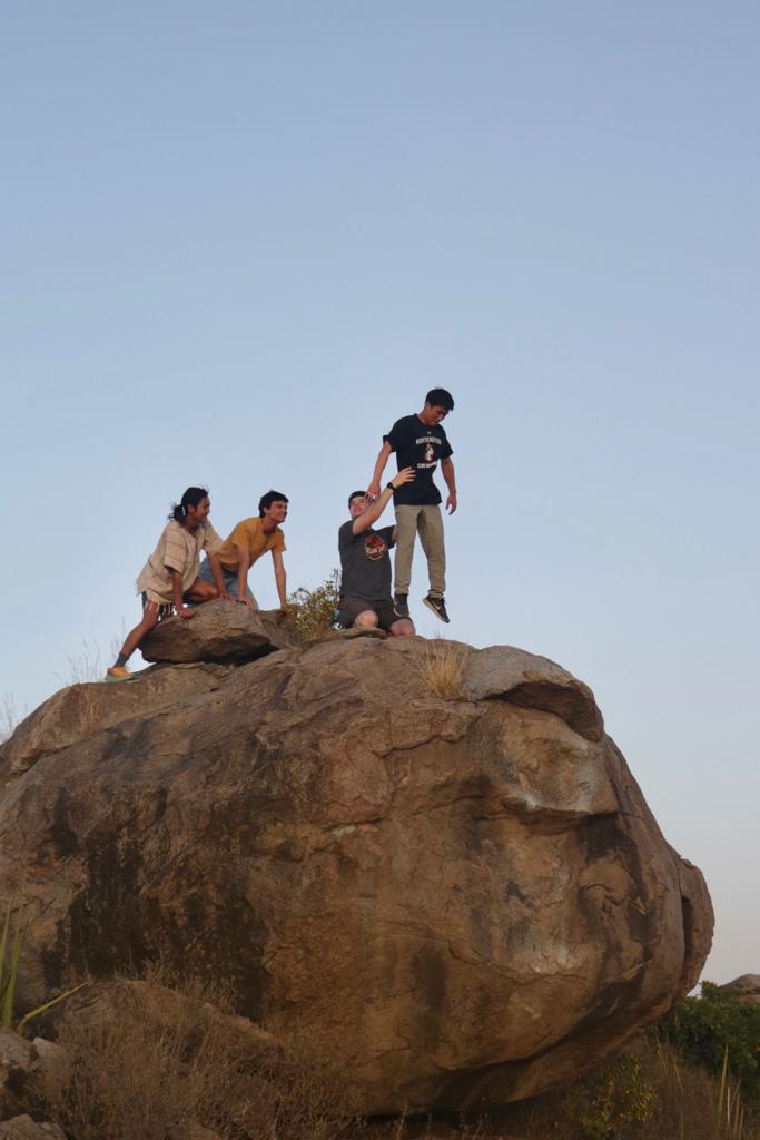 A re-enactment of Simba's birth scene in the Lion King. While on top of a rock, Ezri hoists up Hyun. Kaden and Mahiro are on all fours behind them watching.